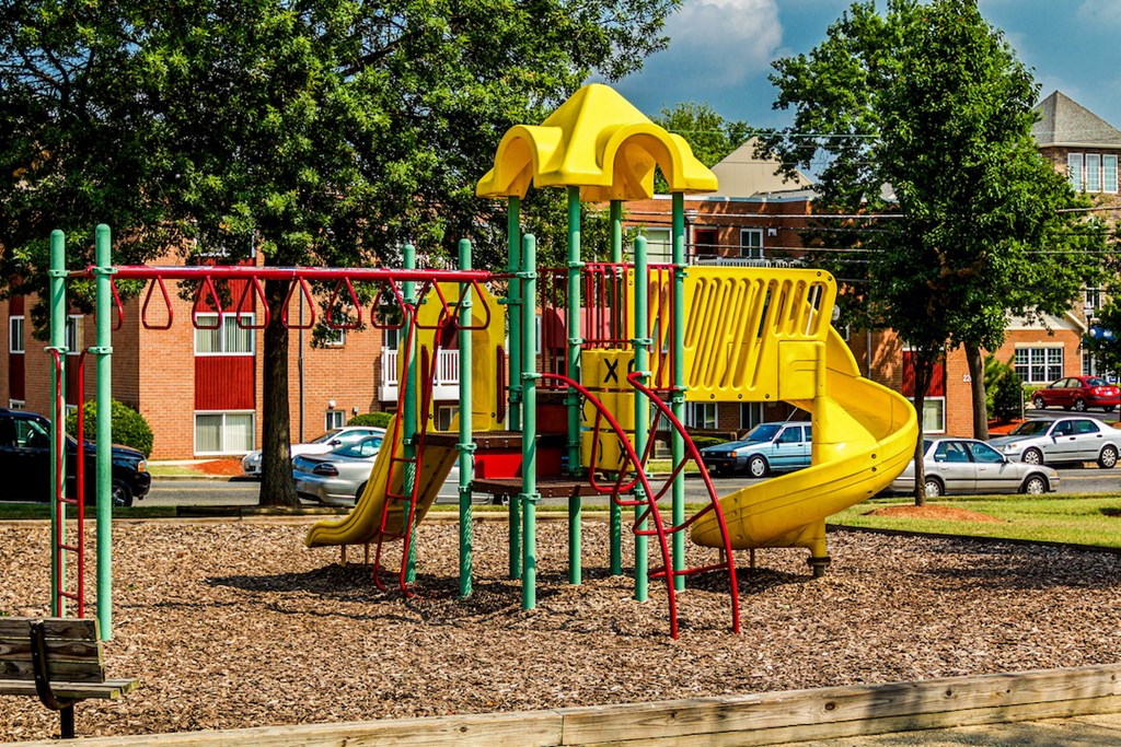 a playground with a yellow swing set