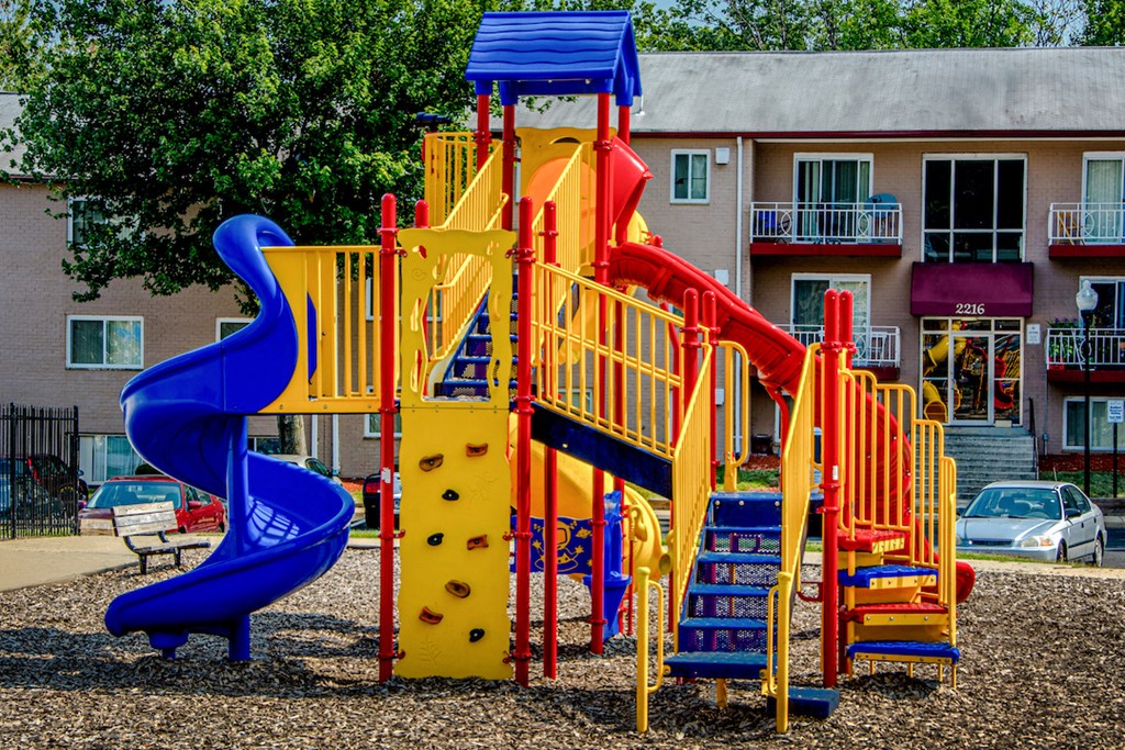 a playground with a blue and yellow slide