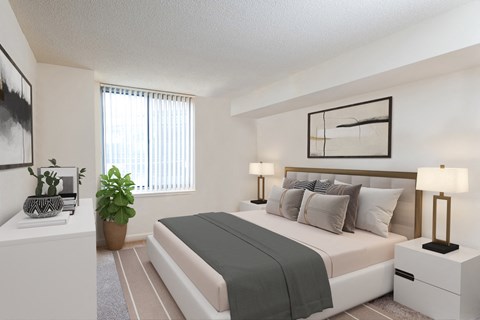 the living room of a bedroom with a bed and a window