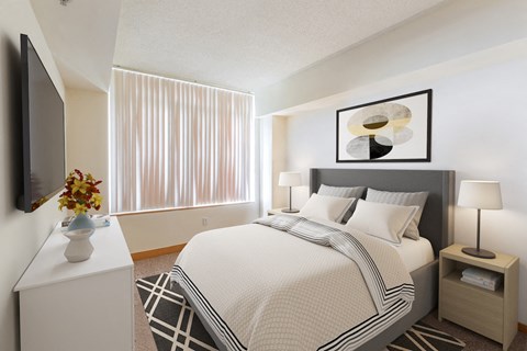 a bedroom with a large bed and a window