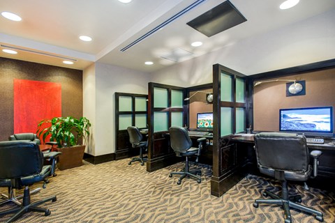 a conference room with desks and chairs and a television