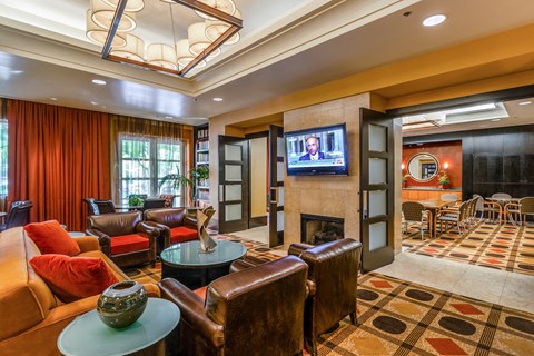 a living room with couches and chairs and a fireplace
