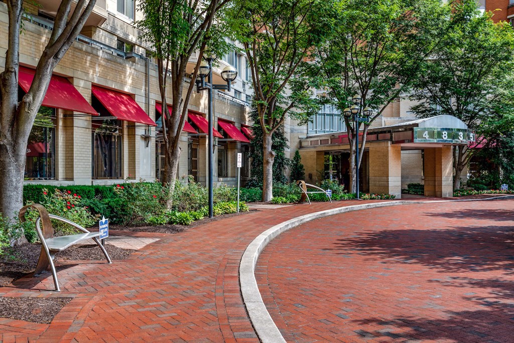 a curved brick sidewalk in front of a building
