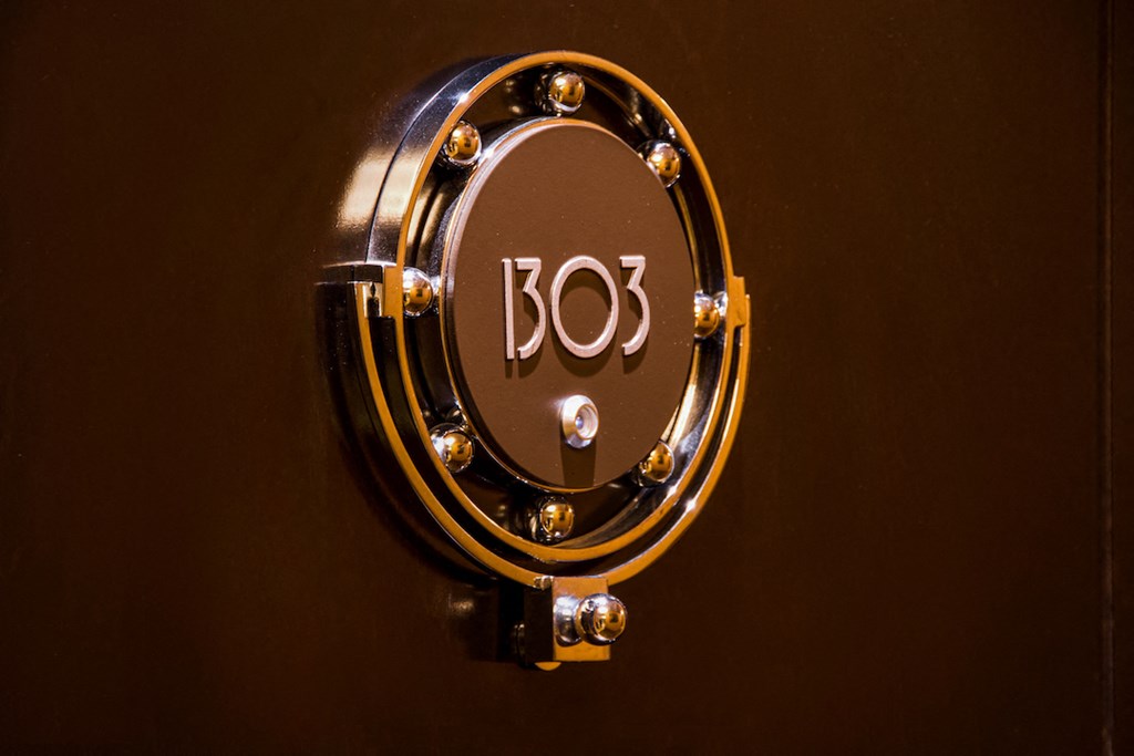 a brown door with a clock on it