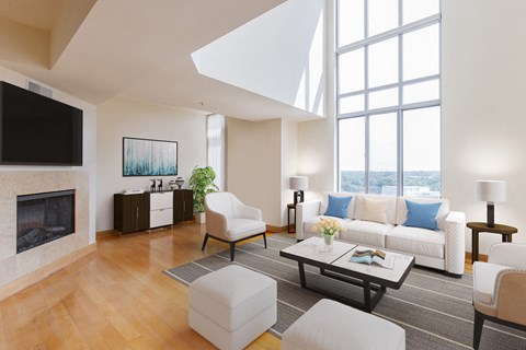 a living room with white furniture and a large window