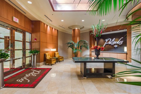 a lobby of a hotel with a table and chairs