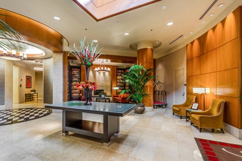 the lobby of a hotel with a table and chairs
