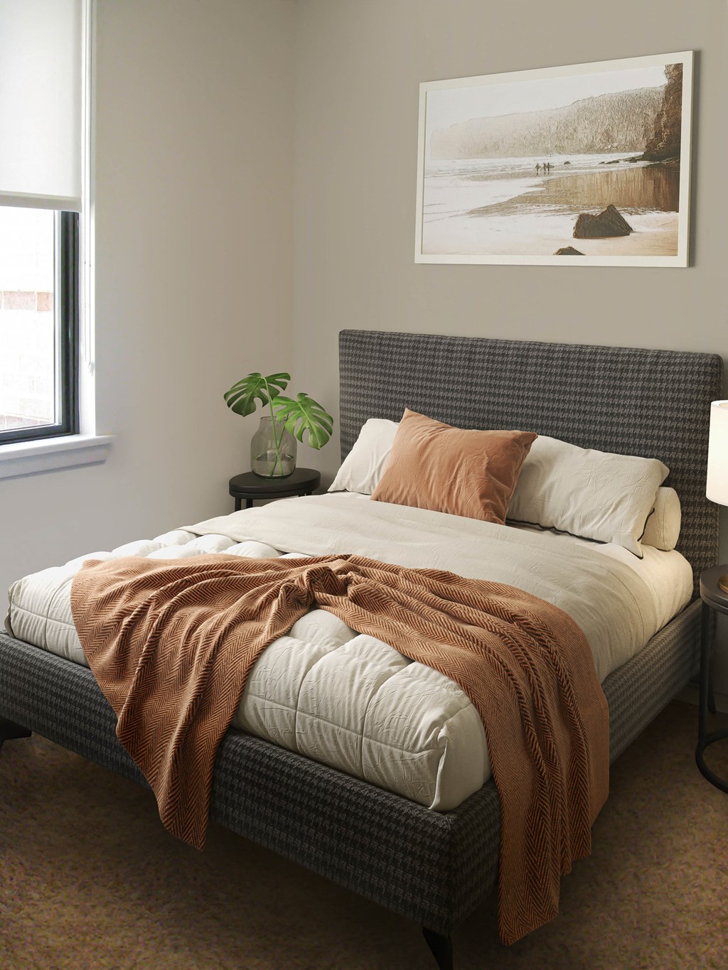 a bedroom with a bed and a painting on the wall