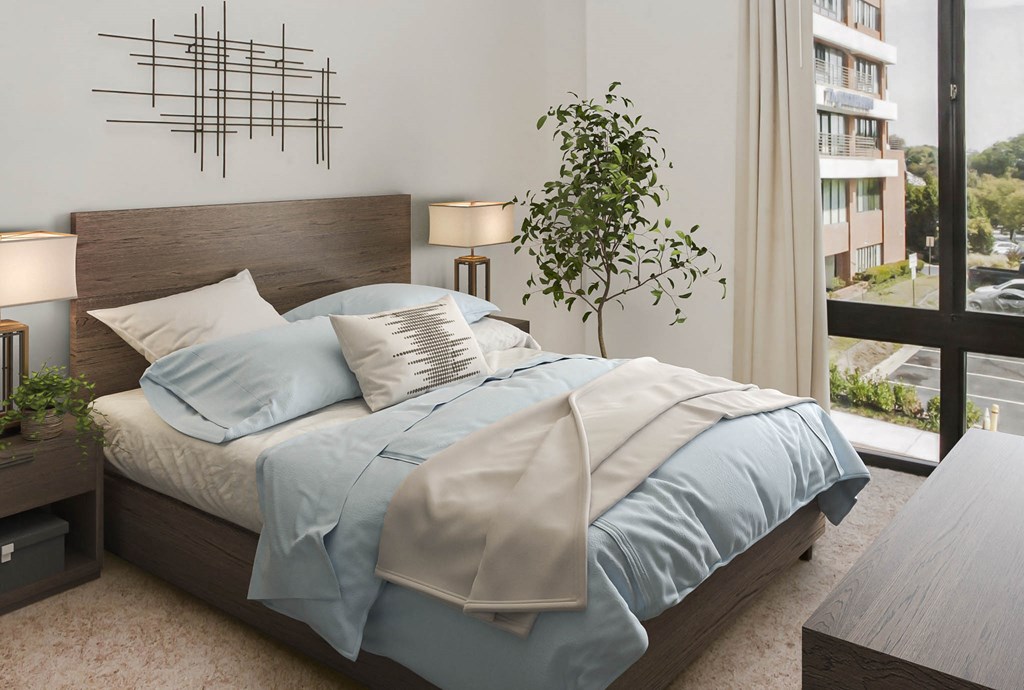 a bedroom with a bed and a large window