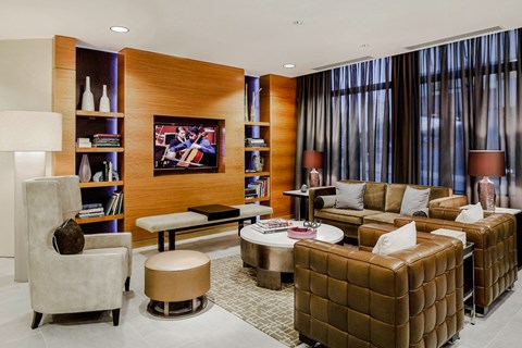 a living room with brown leather furniture and a television