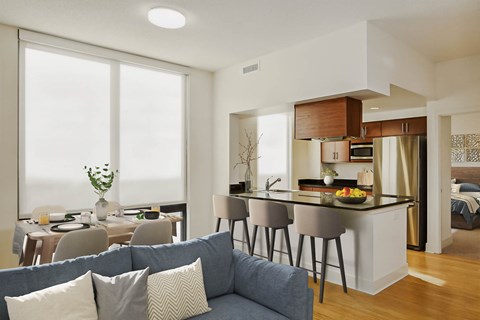 a living room and kitchen with a couch and a table