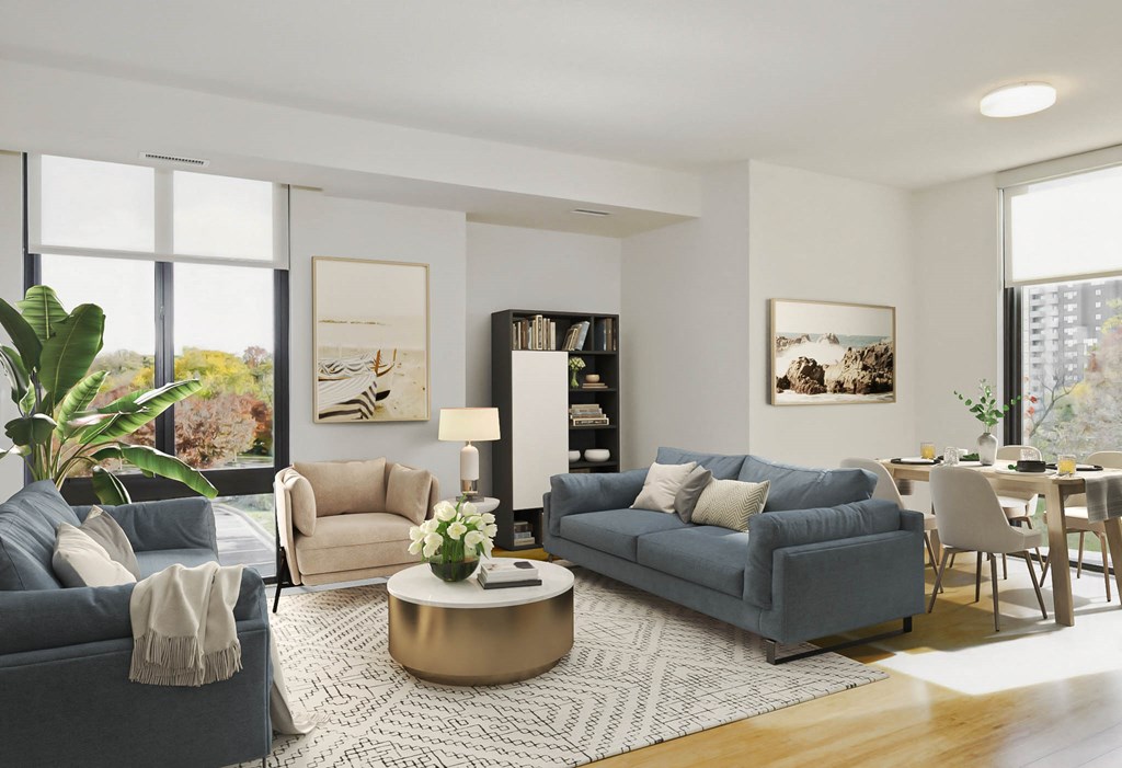 a living room with two blue couches and a round coffee table