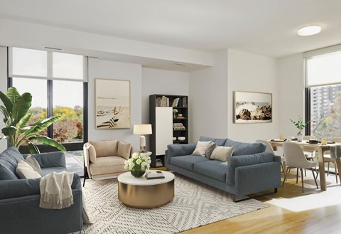 a living room with two blue couches and a round coffee table