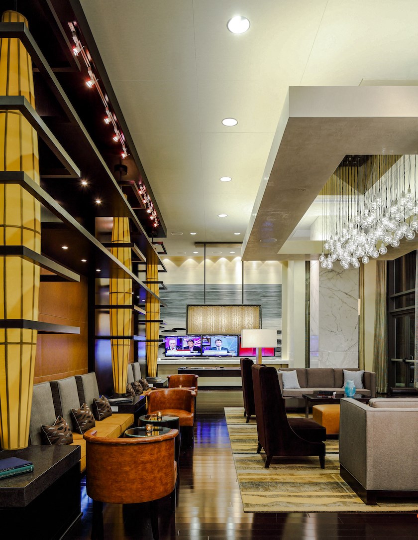 a hotel lobby with couches and chairs and a bar