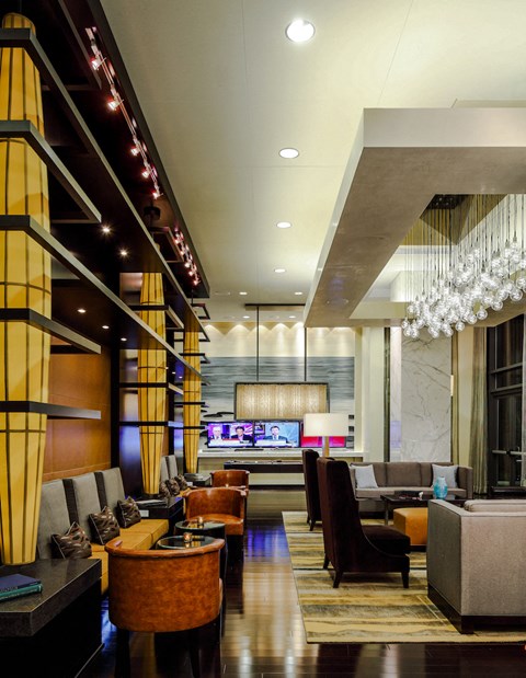 a hotel lobby with couches and chairs and a bar
