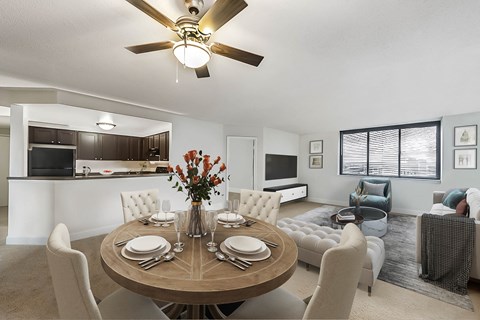 A modern dining room with a round table set for six.