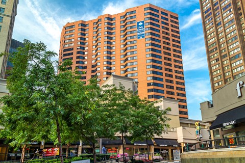 A tall orange building with a blue sign on it.