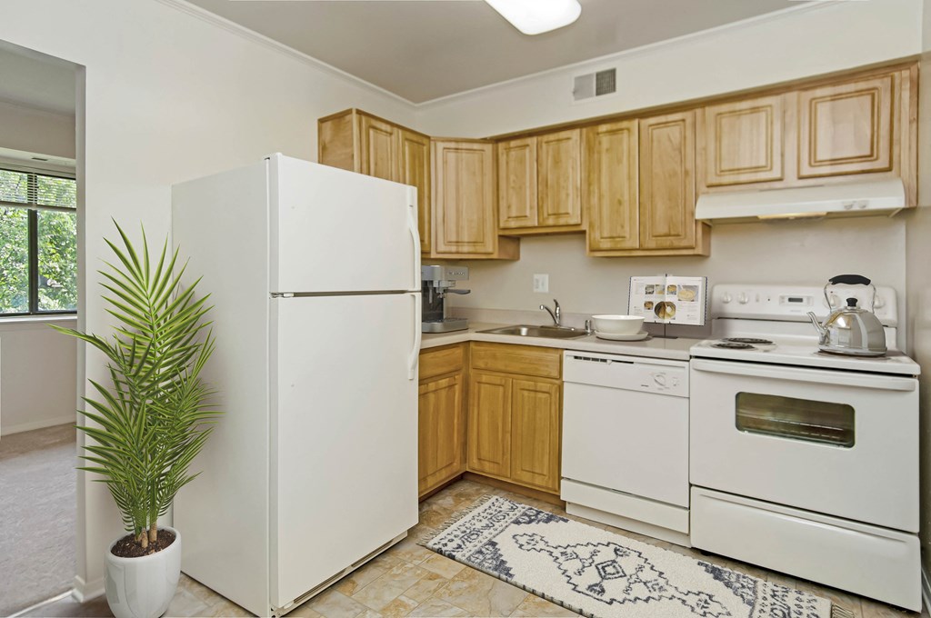 a kitchen with white appliances and wooden cabinets