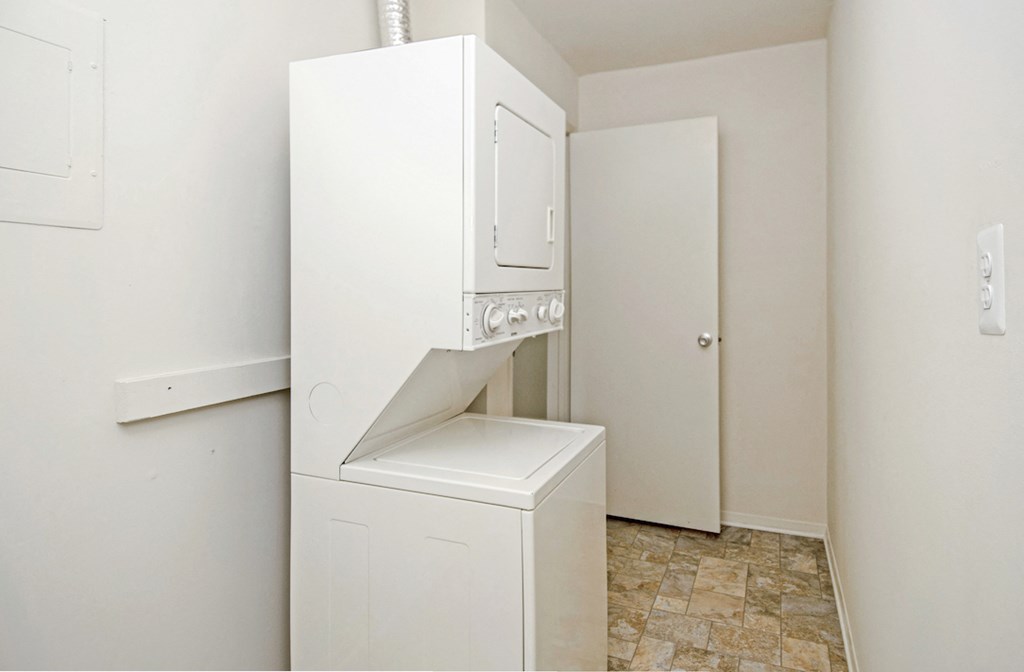 an empty laundry room with a washer and dryer