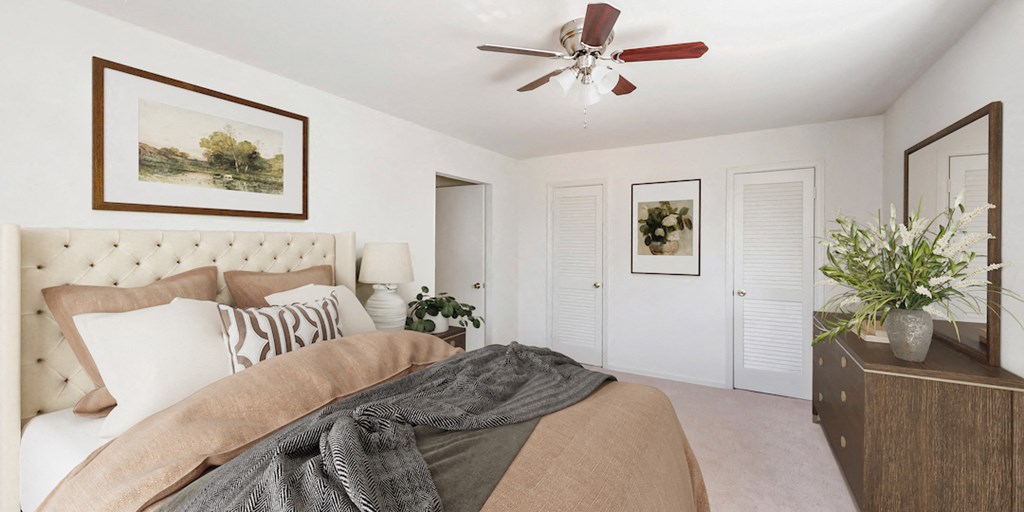 a bedroom with a bed and a ceiling fan