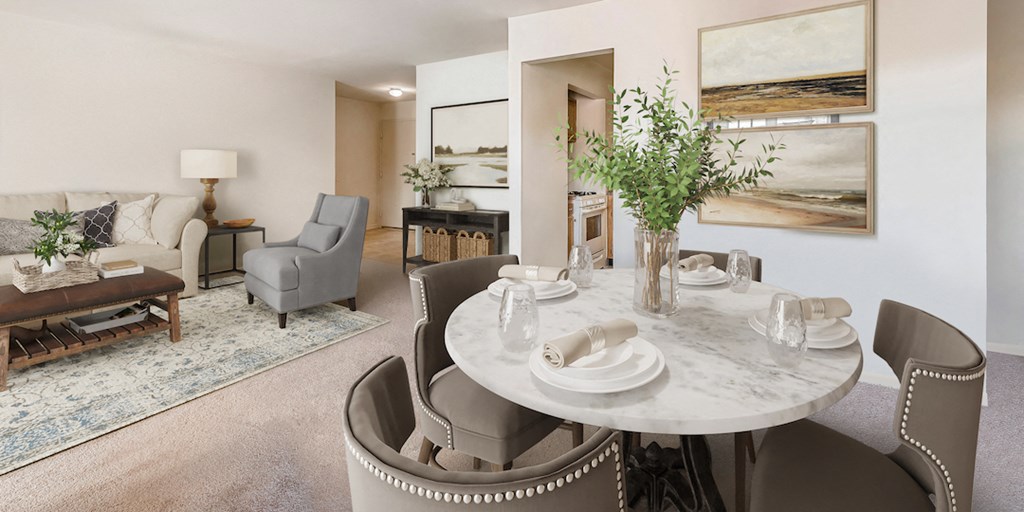 a dining room with a white table and chairs and a living room