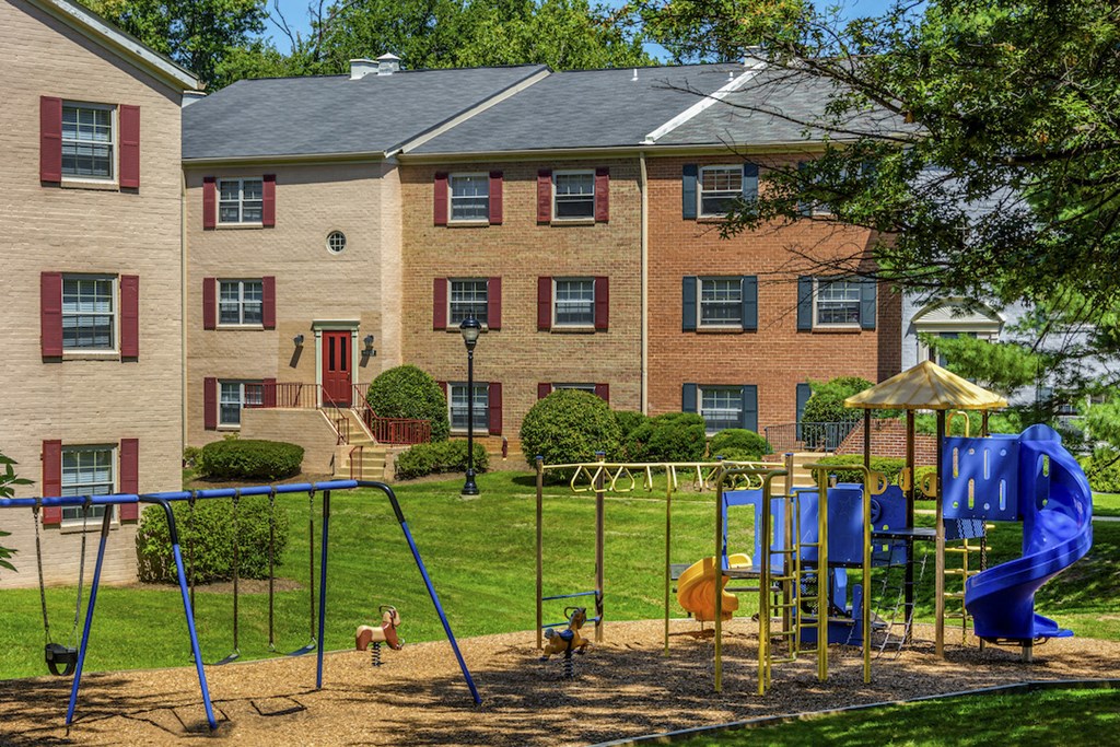 a playground in front of a brick building