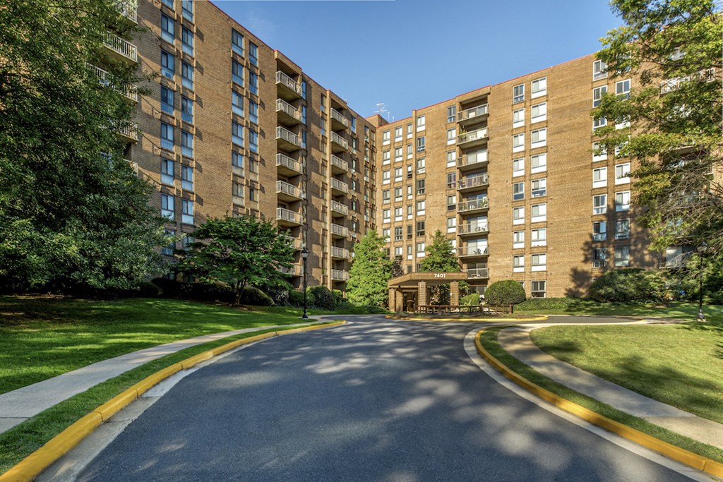 an empty street with a large building on the side of it