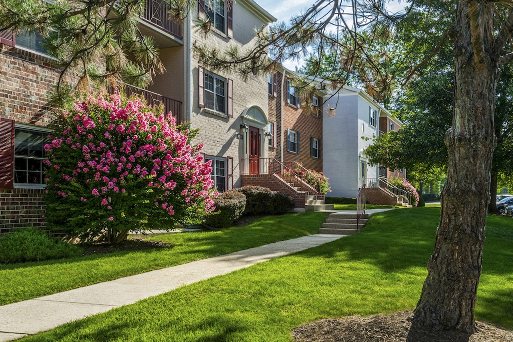 our apartments are located in a quiet neighborhood with green grass and trees