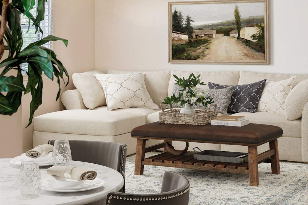 a living room with a couch and a coffee table and a painting on the wall