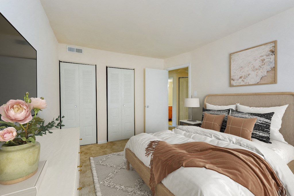 a master bedroom with a large bed and a tv