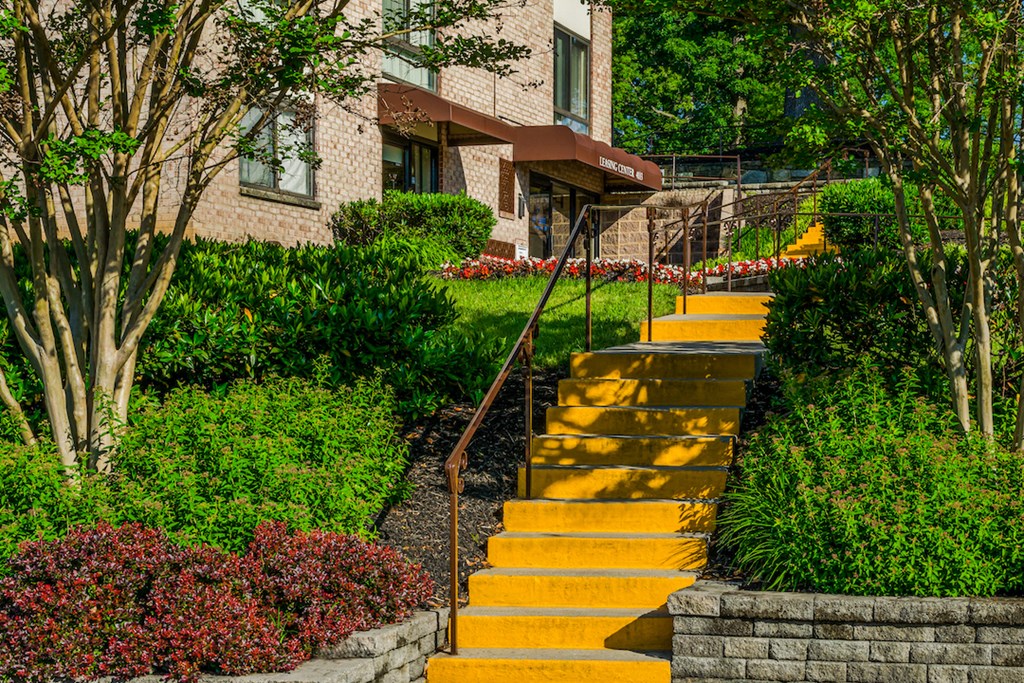 a set of yellow stairs in front of a brick building