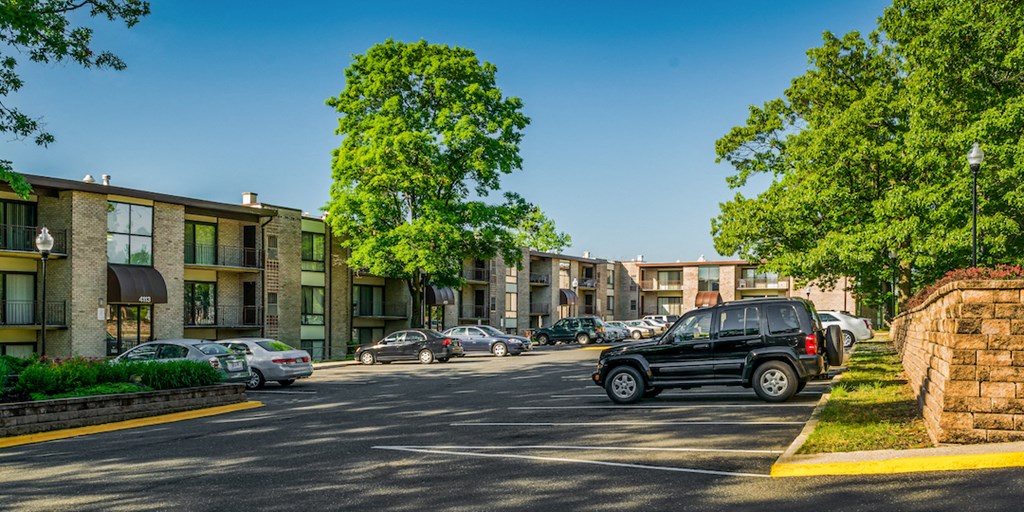 a truck driving down a street in front of apartment buildings