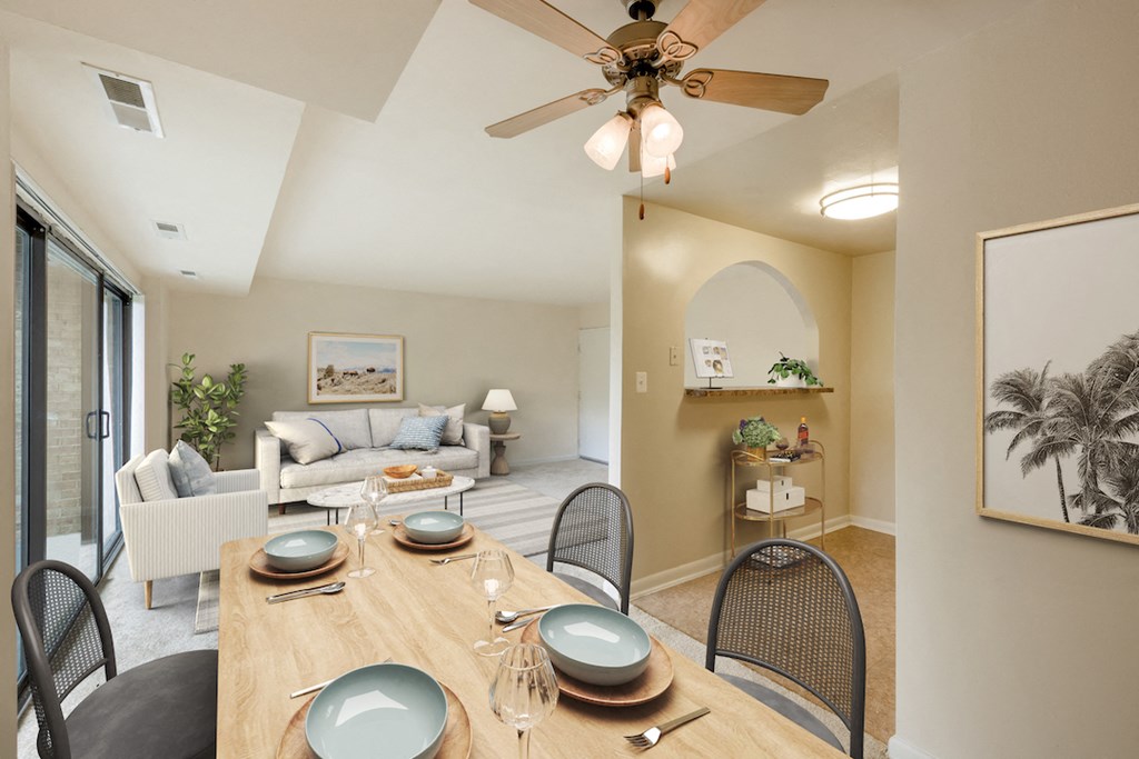 a living room with a dining room table and a ceiling fan