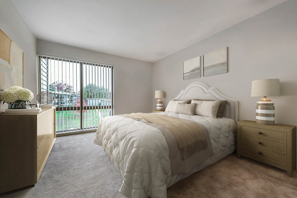 a bedroom with a bed and a sliding glass door
