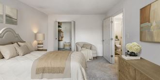 a bedroom with a bed and a closet and a bathroom