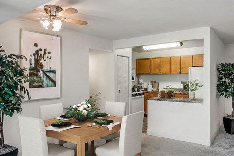 a dining room and kitchen with a table and chairs