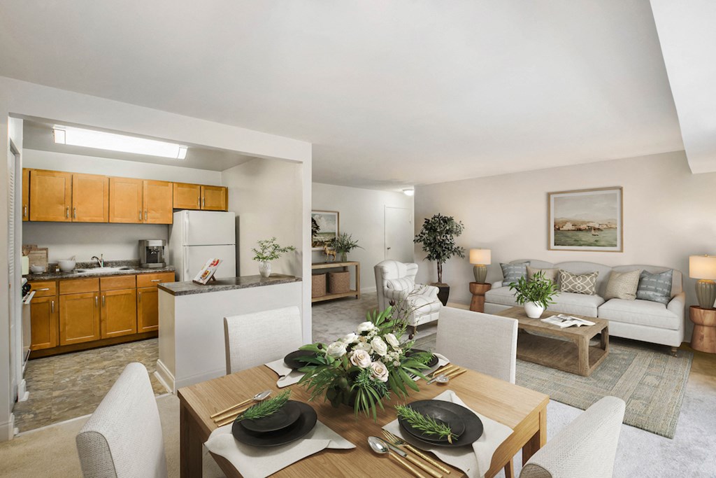a living room and kitchen with a table and chairs