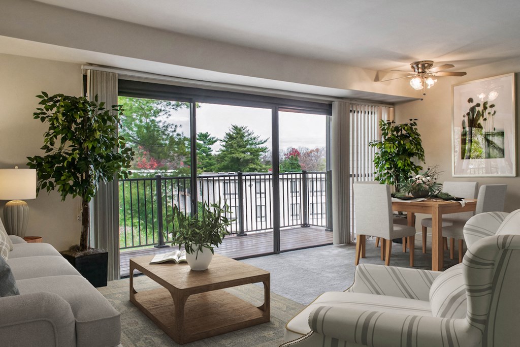 a living room with a sliding glass door to a balcony
