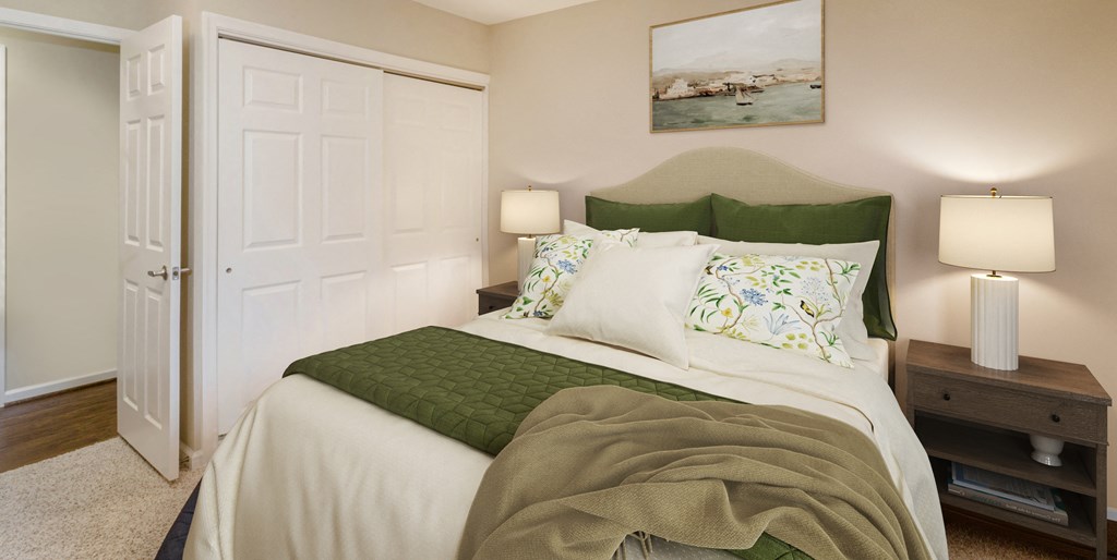 a bedroom with a bed and two lamps and a closet