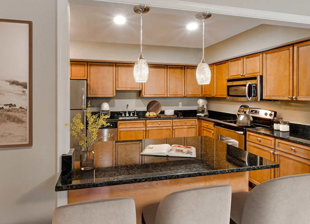 a kitchen with granite counter tops and wooden cabinets