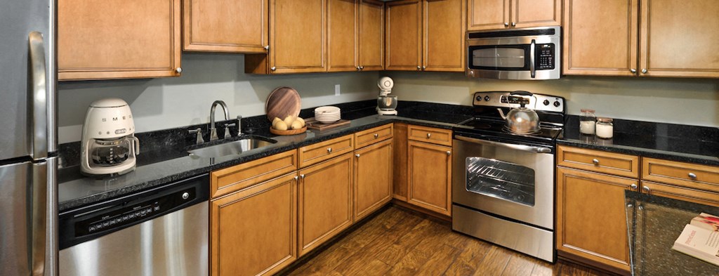 a kitchen with wooden cabinets and stainless steel appliances