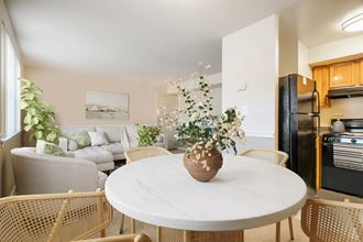 a living room and dining room with a marble table and chairs