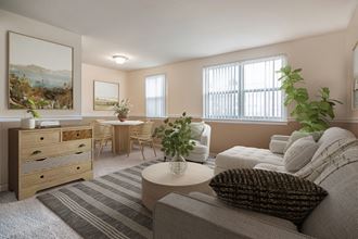 a living room with a couch and a chair and a table
