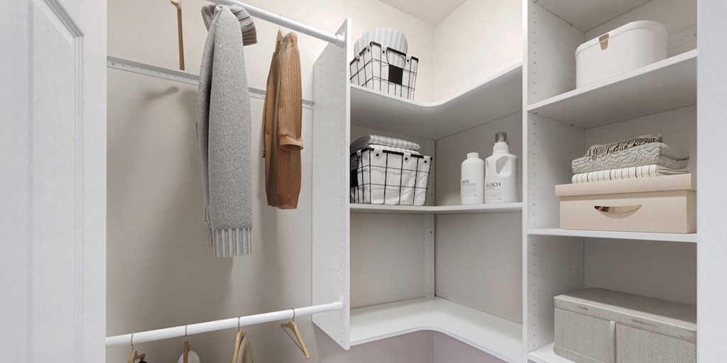 a small walk in closet with shelves and towels