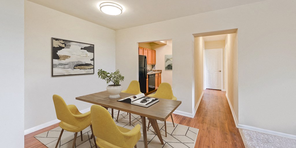a dining room with a wooden table and yellow chairs