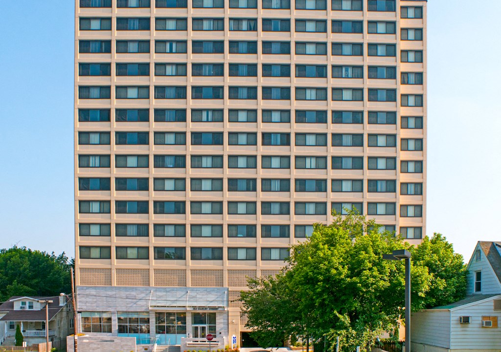 a tall building with trees in front of it