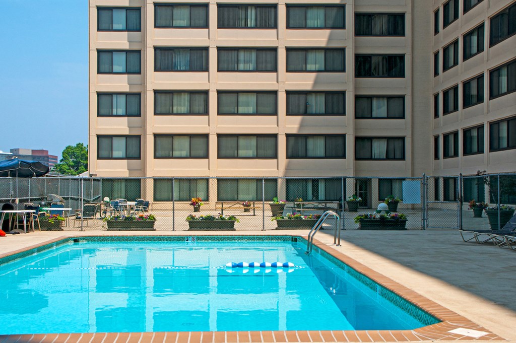 a swimming pool with a hotel in the background