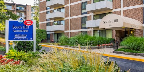 a building with a apartments sign in front of it