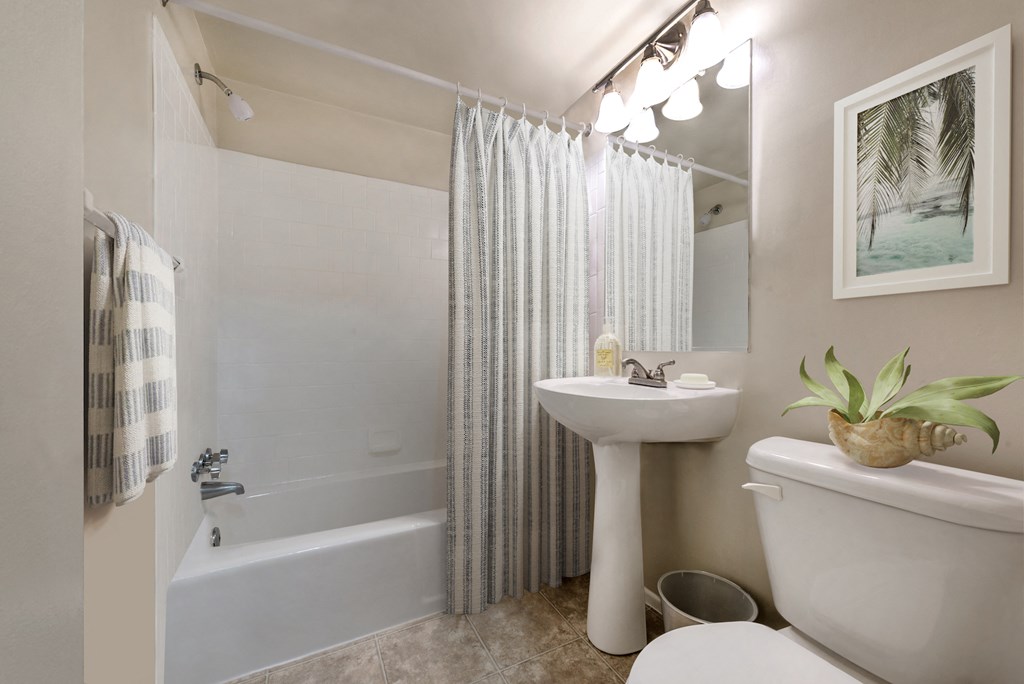 a bathroom with a sink toilet and a tub