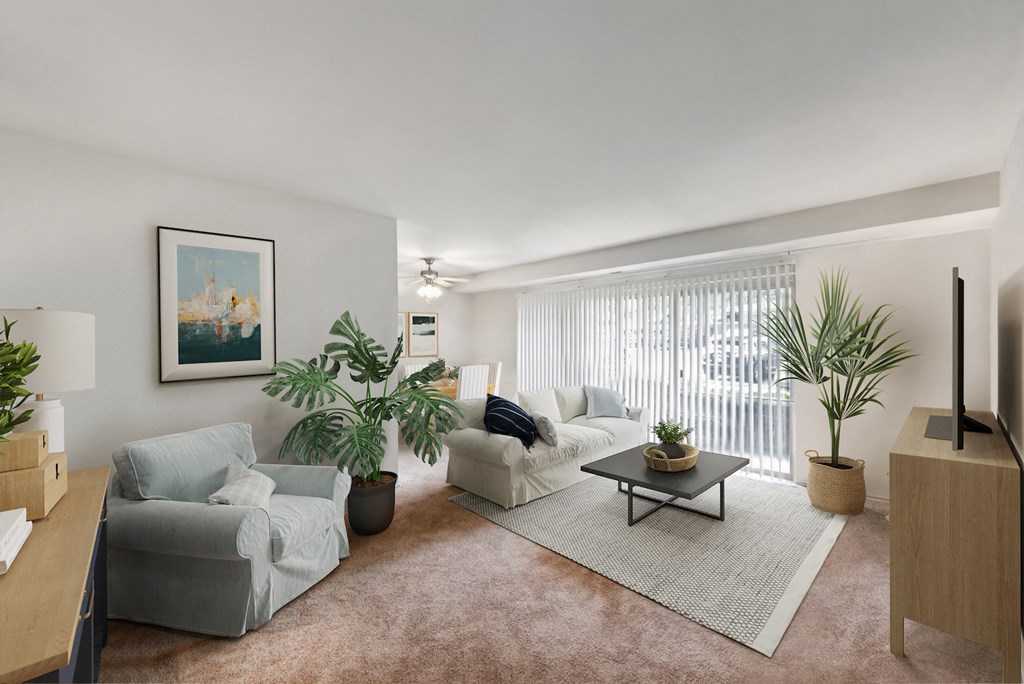 a living room with couches and a coffee table    and a window